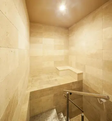 a bathroom with a walk in shower with a bench at Kosher Hotel King David Prague in Prague