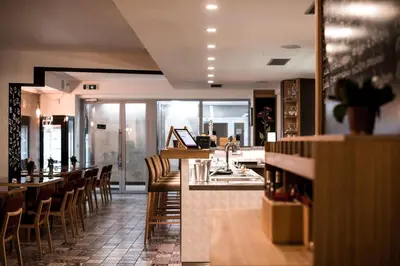 a restaurant with a bar with chairs and a counter at Belvedere in Prague
