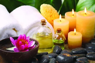 a group of candles and towels with a flower in a bowl at Belvedere in Prague