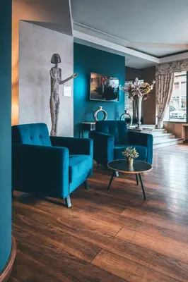 a living room with two blue couches and a table at Belvedere in Prague