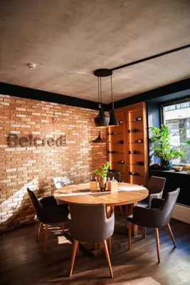 a dining room with a table and chairs and a brick wall at Belvedere in Prague