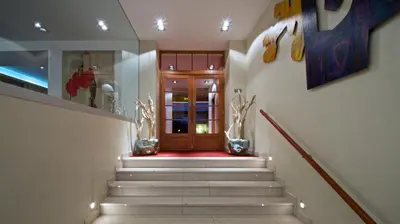 a hallway with stairs leading to a wooden door at Art Hotel Prague in Prague