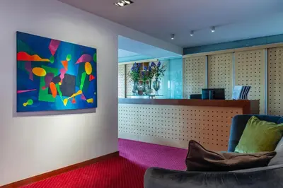 a waiting room with a chair and a painting on the wall at Art Hotel Prague in Prague