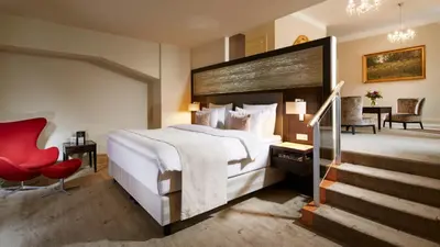 a hotel room with a large bed and a staircase at Aria Hotel Prague in Prague