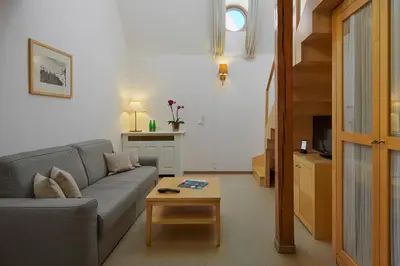 a living room with a couch and a coffee table at Ventana Hotel Prague in Prague