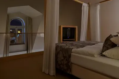 a bedroom with a bed and a large mirror at Ventana Hotel Prague in Prague