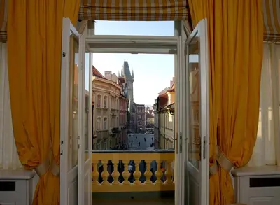 an open door to a balcony with a view of a city at Ventana Hotel Prague in Prague