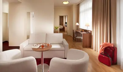 a living room with a couch and chairs and a table at Clarion Hotel Prague Old Town in Prague