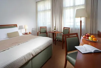 a hotel room with a bed and a bowl of fruit on a table at Clarion Hotel Prague Old Town in Prague