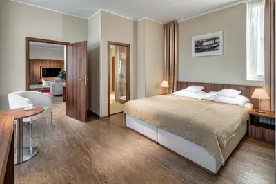 a bedroom with a bed and a living room at Clarion Hotel Prague Old Town in Prague
