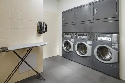 a laundry room with two washer and dryer at Comfort Hotel Prague City in Prague