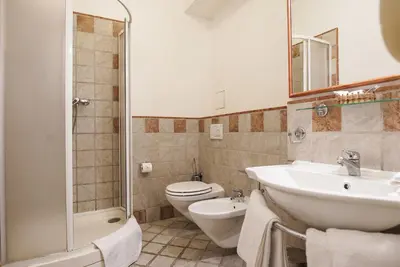 a bathroom with a sink and a toilet and a shower at Hotel Tivoli Prague in Prague
