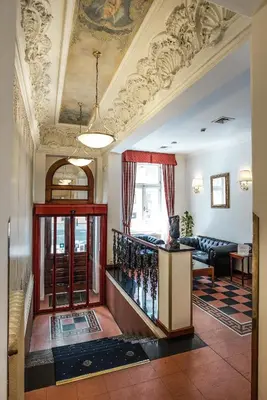 a living room with a bunch of wine bottles at Hotel Tivoli Prague in Prague