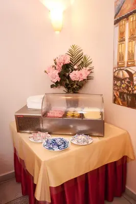 a table with plates of food on top of it at Hotel Residence Select in Prague