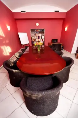 a red room with a table and black chairs at Hotel Residence Select in Prague
