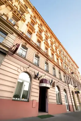 a large building with an arch in front of it at Hotel Residence Select in Prague
