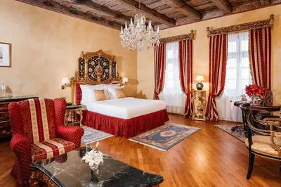 a bedroom with a bed and a chandelier at Alchymist Grand Hotel and Spa in Prague