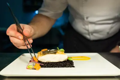 a person eating a piece of food on a plate at Alchymist Grand Hotel and Spa in Prague