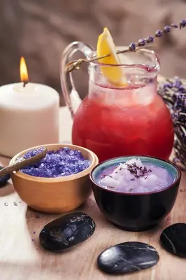 a table with a candle and a jar of purple drink at Alchymist Grand Hotel and Spa in Prague