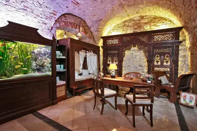 a dining room with a table and an aquarium at Alchymist Grand Hotel and Spa in Prague