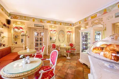 a large room with tables and chairs and a bakery at Alchymist Grand Hotel and Spa in Prague