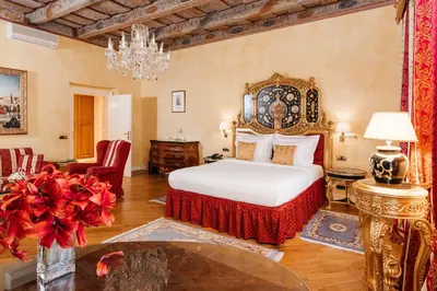 a bedroom with a bed and a chandelier at Alchymist Grand Hotel and Spa in Prague