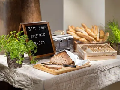 a table topped with a loaf of bread and a sandwich at Hotel Michael in Prague
