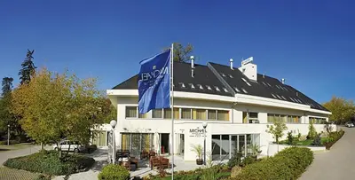 a building with a blue flag in front of it at Hotel Michael in Prague