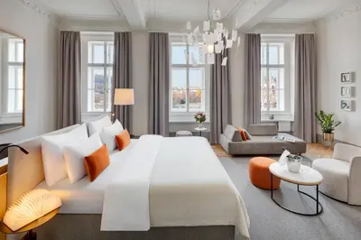 a bedroom with a large bed and a living room at Hotel BOOKQUET in Prague
