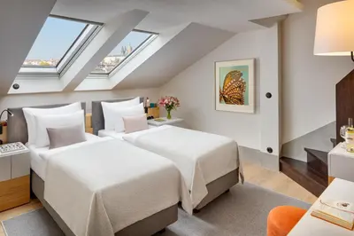 two beds in a room with skylights at Hotel BOOKQUET in Prague