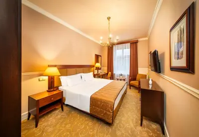 a hotel room with a bed and a television at Esplanade Hotel Prague in Prague