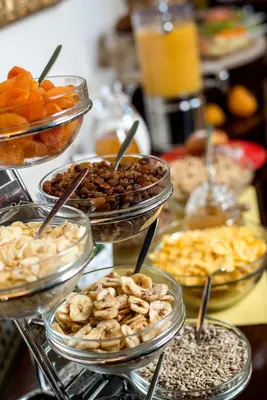 a table with bowls of different types of food at Boutique Hotel Seven Days in Prague