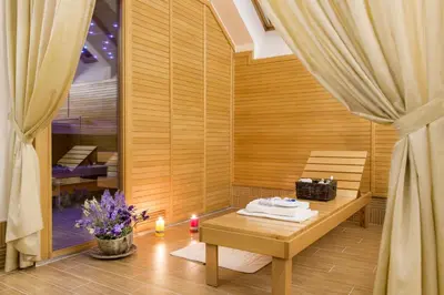 a room with a bench and a table with a candle at Boutique Hotel Seven Days in Prague