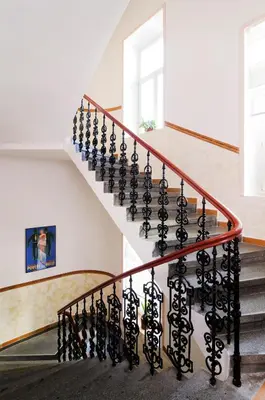 a spiral staircase in a home with white walls at Hotel Praga 1 in Prague