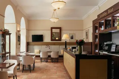 a restaurant with a bar and tables and chairs at Hotel Praga 1 in Prague