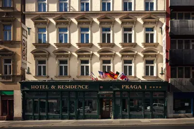 a hotel and residence with flags on top of it at Hotel Praga 1 in Prague