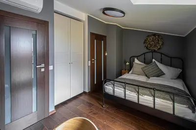 a bedroom with a bed and a sliding glass door at Quite Loft with Balcony and 3 Air Conditioners in Prague