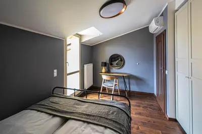 a bedroom with a bed and a table in it at Quite Loft with Balcony and 3 Air Conditioners in Prague