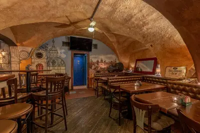 a restaurant with a bunch of tables and chairs at Studio Nicolas II Prague in Prague