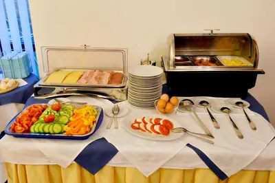 a table with a buffet of food on it at Hotel Coronet in Prague
