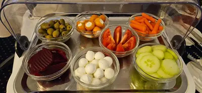 a group of bowls of vegetables on a table at Hotel Coronet in Prague