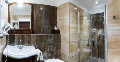 a bathroom with a sink and a shower at Hotel Residence U Černého Orla in Prague