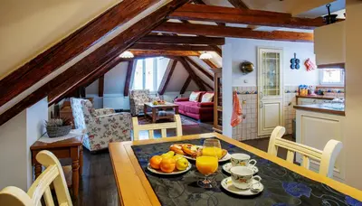 a kitchen and dining room with a table with fruit on it at Hotel Residence U Černého Orla in Prague