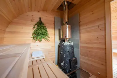 a room with a wood paneled wall with a stove at Wellness Kokořín in Kokořín