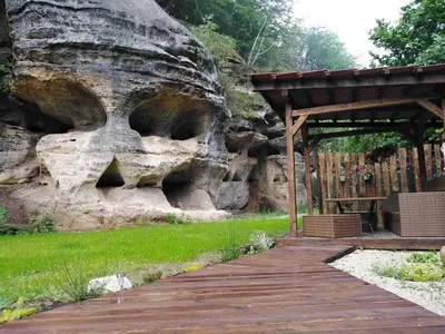 a wooden walkway leading to a rock wall at Wellness Kokořín in Kokořín