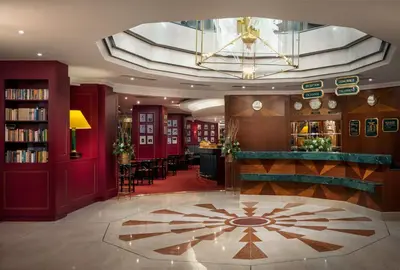 a hotel lobby with a library and a bar at Art Nouveau Palace Hotel in Prague