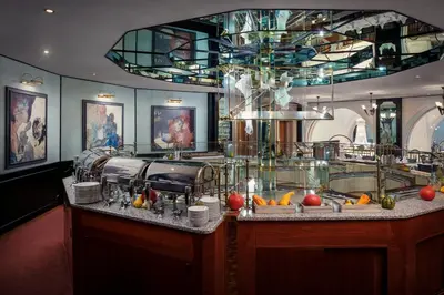 a restaurant with a counter with a buffet at Art Nouveau Palace Hotel in Prague