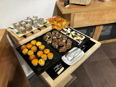 a table with several different types of food on it at The Golden Wheel Hotel in Prague