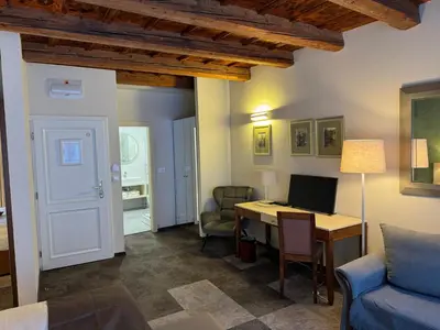 a living room with a desk with a computer on it at The Golden Wheel Hotel in Prague