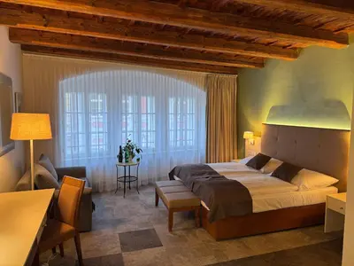 a bedroom with a large bed and a window at The Golden Wheel Hotel in Prague